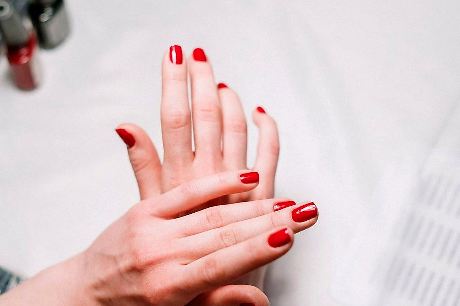 Free Professional hand treatment features a stylish red manicure at a modern nail salon. Stock Photo
